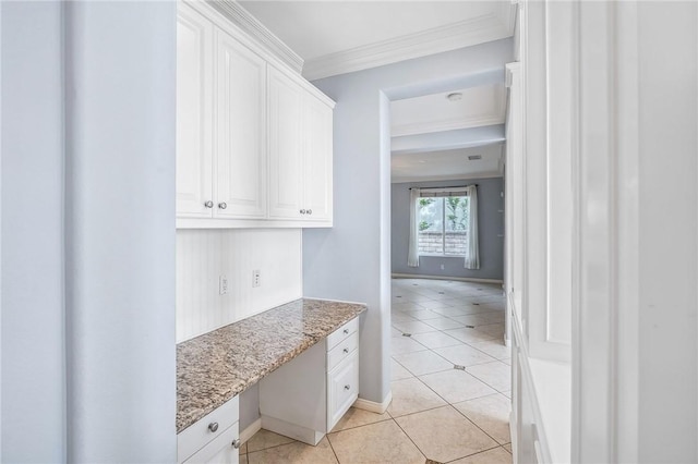 24274 Reyes Adobe Way, Valencia, CA 91354 - kitchen with crown molding, white cabinets, baseboards, and light tile patterned flooring