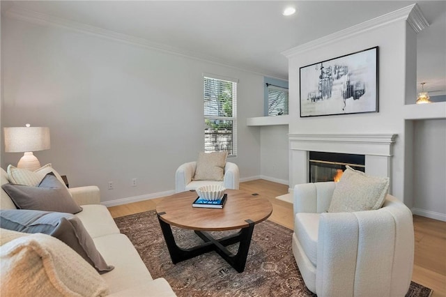 24274 Reyes Adobe Way, Valencia, CA 91354 - living area featuring crown molding, a glass covered fireplace, baseboards, wood finished floors, and recessed lighting