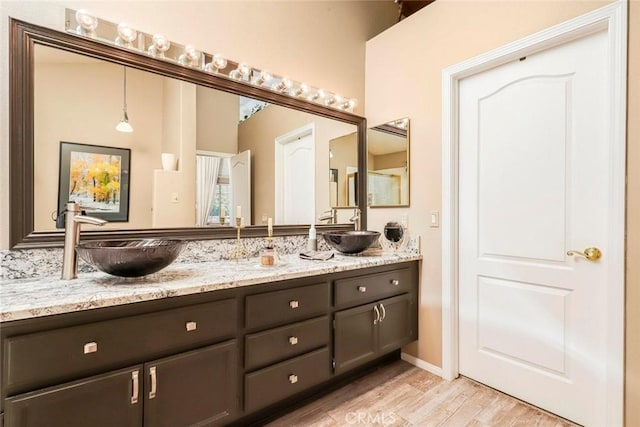 5618 Gardendale Ln, Palmdale, CA 93551 - bathroom featuring double vanity and wood finished floors