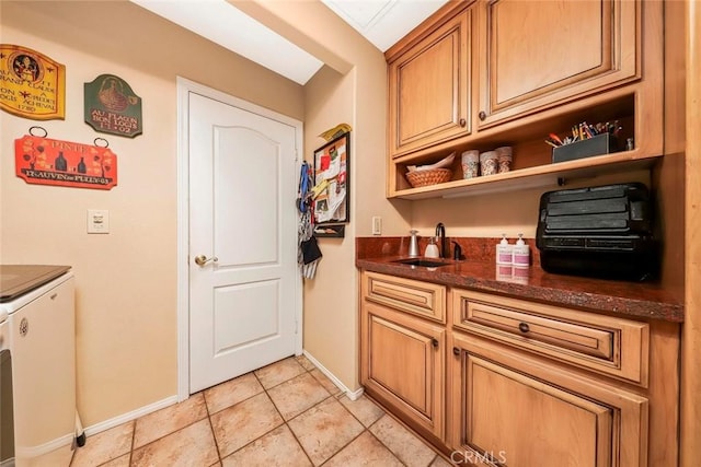5618 Gardendale Ln, Palmdale, CA 93551 - kitchen with open shelves, baseboards, a sink, washer and clothes dryer, and dark stone counters