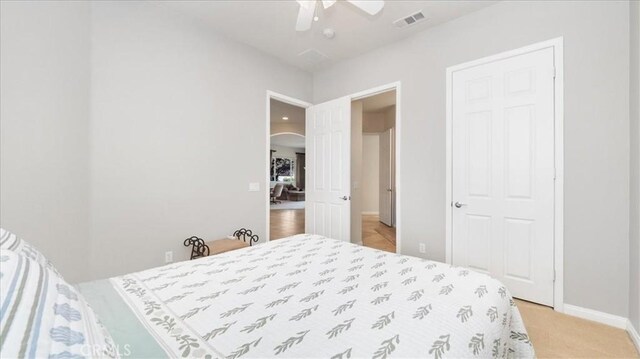 19484 Vermillion Ln, Apple Valley, CA 92308 - bedroom featuring arched walkways, baseboards, and a ceiling fan