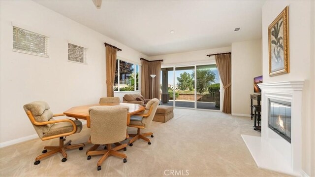 19484 Vermillion Ln, Apple Valley, CA 92308 - dining space with carpet flooring, a glass covered fireplace, and baseboards