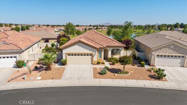 19484 Vermillion Ln, Apple Valley, CA 92308 - mediterranean / spanish house with concrete driveway, a tile roof, an attached garage, and stucco siding