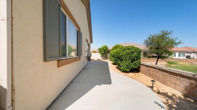 19484 Vermillion Ln, Apple Valley, CA 92308 - view of home's exterior with stucco siding and a patio area