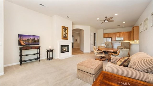 19484 Vermillion Ln, Apple Valley, CA 92308 - living room featuring ceiling fan, arched walkways, baseboards, recessed lighting, and light colored carpet