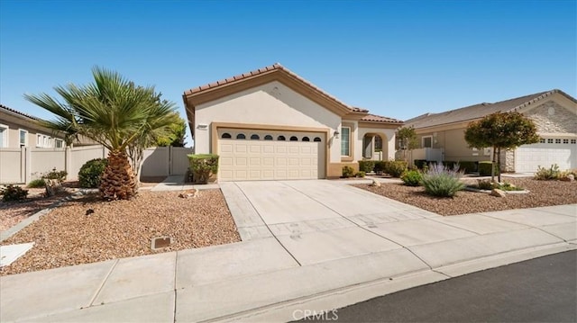 19484 Vermillion Ln, Apple Valley, CA 92308 - mediterranean / spanish-style home featuring stucco siding, concrete driveway, a garage, and a tile roof