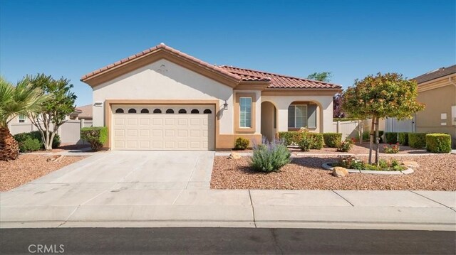 19484 Vermillion Ln, Apple Valley, CA 92308 - mediterranean / spanish home featuring stucco siding, a garage, concrete driveway, and a tiled roof