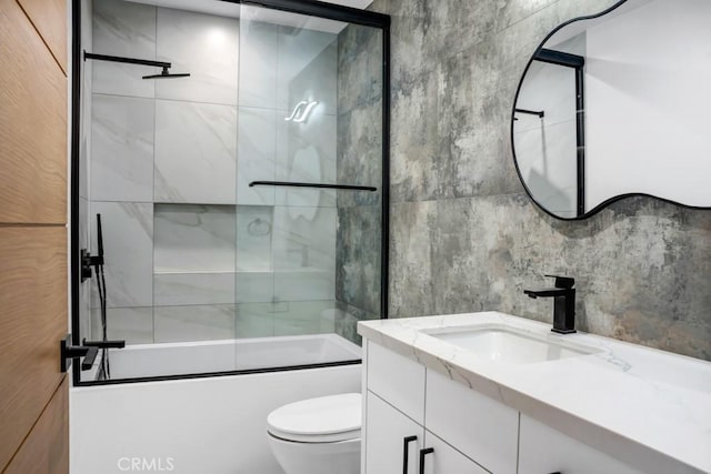 14899 Round Vly, Sherman Oaks, CA 91403 - bathroom with vanity, bath / shower combo with glass door, toilet, and tile walls