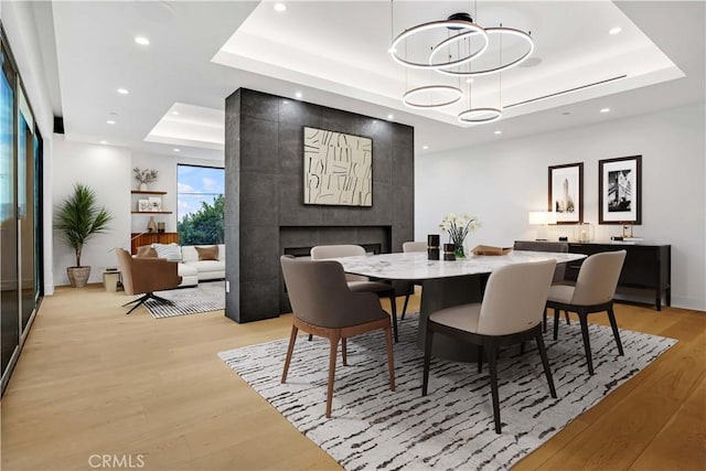 14899 Round Vly, Sherman Oaks, CA 91403 - dining area featuring a raised ceiling, light wood finished floors, recessed lighting, and a fireplace