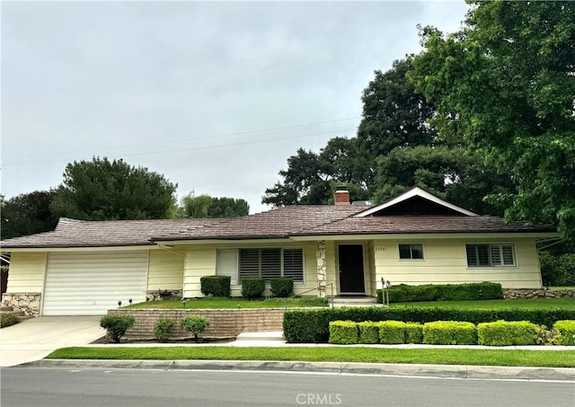 23307 Maple St, Newhall, CA 91321 - single story home with concrete driveway, a chimney, and a garage