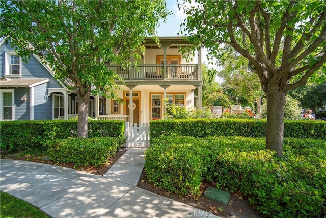 1 Evergreen Rd, Ladera Ranch, CA 92694 - view of front of home with a balcony, a gate, a fenced front yard, stucco siding, and covered porch