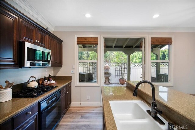 1 Evergreen Rd, Ladera Ranch, CA 92694 - kitchen with black appliances, a sink, light wood finished floors, crown molding, and dark brown cabinets