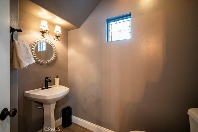 1 Evergreen Rd, Ladera Ranch, CA 92694 - bathroom featuring toilet, lofted ceiling, baseboards, and wood finished floors