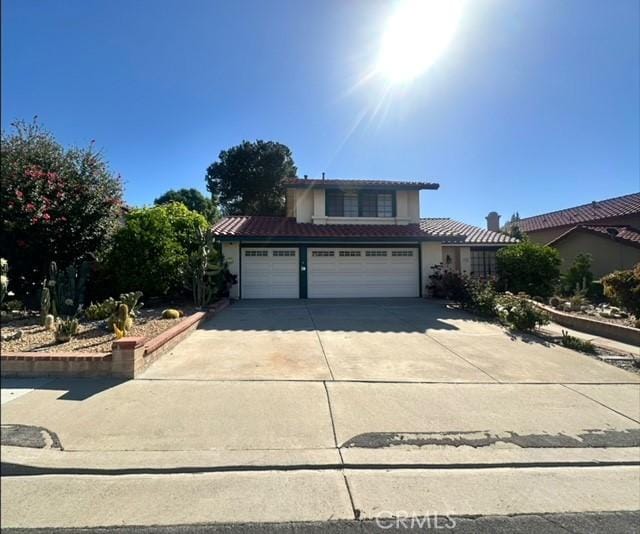 650 Bull Frog Cir, Walnut, CA 91789 - traditional home with a tile roof, stucco siding, driveway, and an attached garage