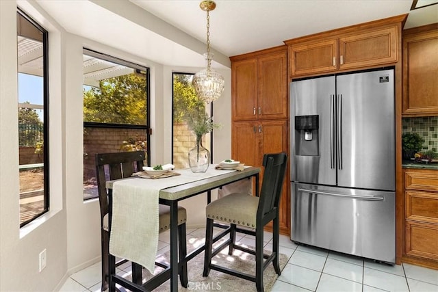 650 Bull Frog Cir, Walnut, CA 91789 - kitchen with stainless steel fridge with ice dispenser, brown cabinets, light tile patterned flooring, a chandelier, and decorative light fixtures