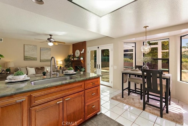 650 Bull Frog Cir, Walnut, CA 91789 - kitchen featuring french doors, brown cabinetry, light tile patterned flooring, decorative light fixtures, and ceiling fan