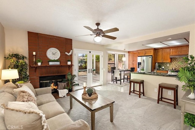 650 Bull Frog Cir, Walnut, CA 91789 - living area with a ceiling fan, a fireplace, french doors, and light carpet