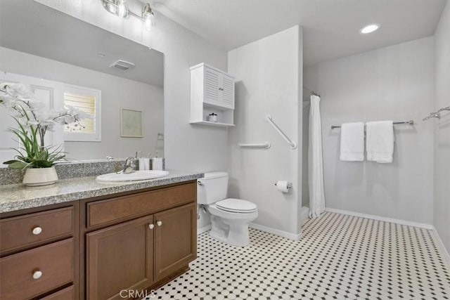 579 Camino Mercado Unit 504, Arroyo Grande, CA 93420 - bathroom featuring vanity, toilet, a shower with curtain, and baseboards