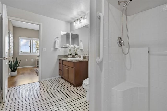 579 Camino Mercado Unit 504, Arroyo Grande, CA 93420 - bathroom featuring vanity, tiled shower, toilet, and baseboards
