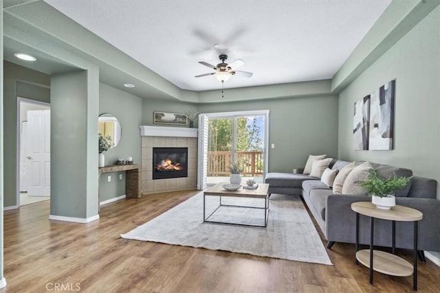 579 Camino Mercado Unit 504, Arroyo Grande, CA 93420 - living area featuring ceiling fan, wood finished floors, a fireplace, and baseboards