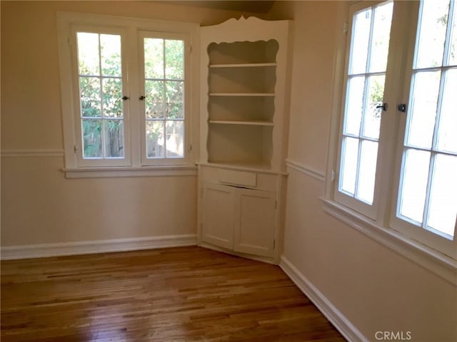 11958 Sarah St, Valley Village, CA 91607 - unfurnished dining area with plenty of natural light, wood finished floors, and baseboards