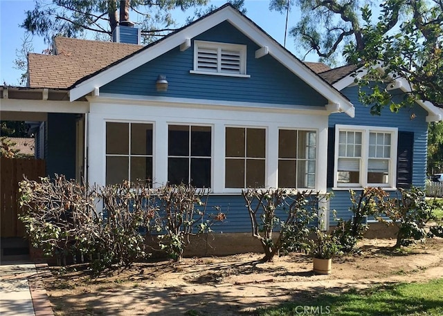 11958 Sarah St, Valley Village, CA 91607 - view of home's exterior featuring a chimney and roof with shingles