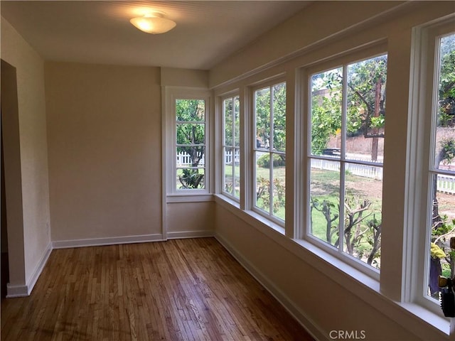 11958 Sarah St, Valley Village, CA 91607 - unfurnished sunroom with wood finished floors and baseboards