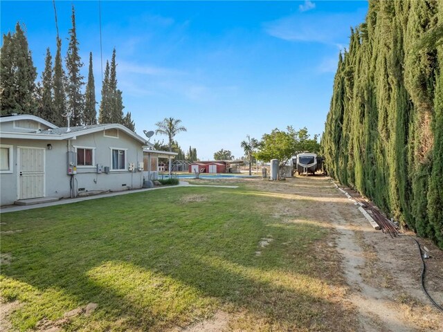 1654 W S Ave, Fresno, CA 93706 - view of green lawn featuring a pool and dirt driveway