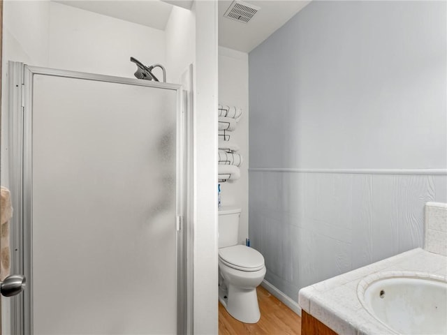 1654 W S Ave, Fresno, CA 93706 - full bathroom featuring a stall shower, toilet, wood finished floors, vanity, and wainscoting