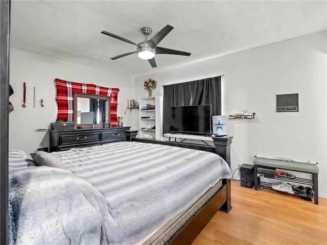 1654 W S Ave, Fresno, CA 93706 - bedroom with wood finished floors, ceiling fan, and a textured ceiling