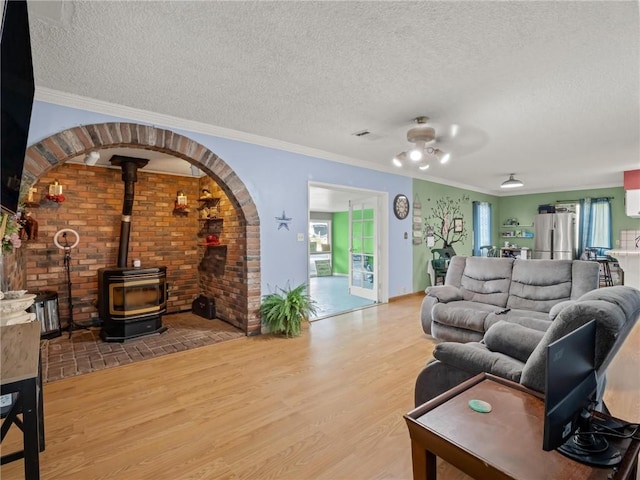 1654 W S Ave, Fresno, CA 93706 - living room with a textured ceiling, a wood stove, wood finished floors, and crown molding