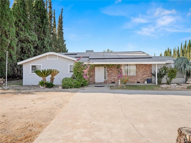 1654 W S Ave, Fresno, CA 93706 - ranch-style house featuring solar panels, brick siding, and a shingled roof