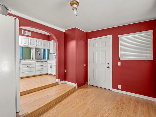 1654 W S Ave, Fresno, CA 93706 - foyer entrance with light wood-style flooring, arched walkways, and baseboards