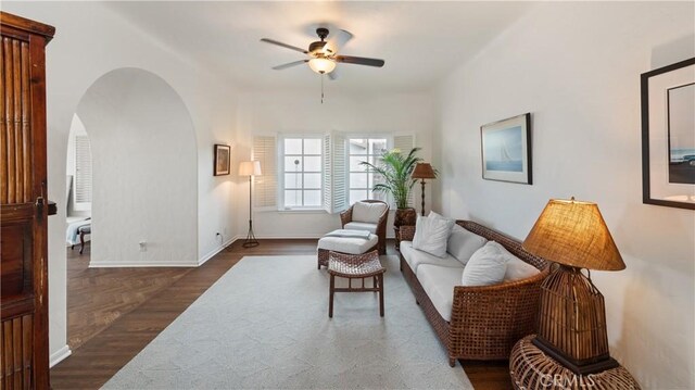 1305 E Balboa Blvd, Newport Beach, CA 92661 - living area featuring ceiling fan, dark wood-type flooring, arched walkways, and baseboards