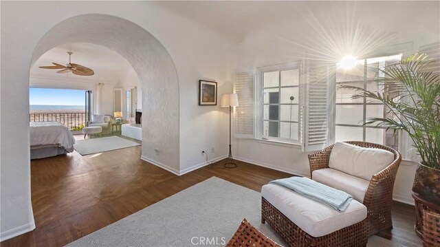 1305 E Balboa Blvd, Newport Beach, CA 92661 - sitting room with arched walkways, baseboards, ceiling fan, and wood finished floors