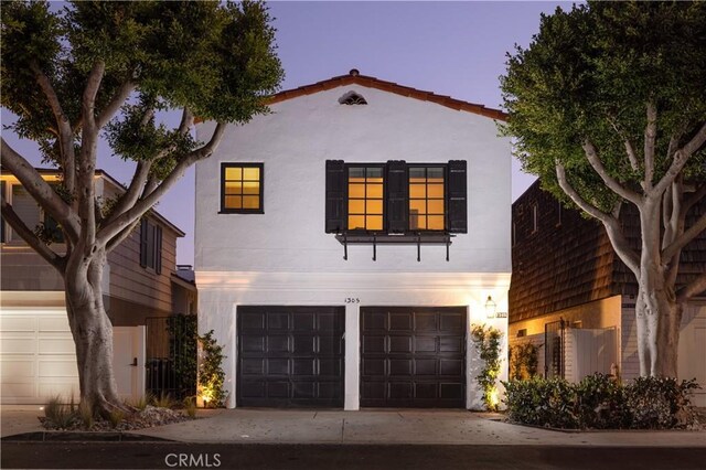 1305 E Balboa Blvd, Newport Beach, CA 92661 - view of front of house with a garage, stucco siding, and concrete driveway