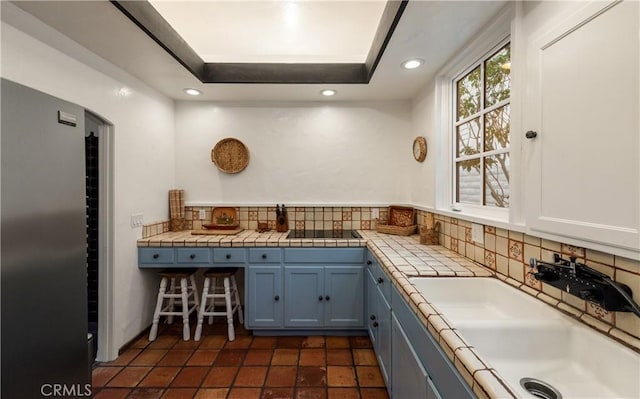 1305 E Balboa Blvd, Newport Beach, CA 92661 - kitchen with backsplash, a sink, recessed lighting, blue cabinets, and black electric cooktop