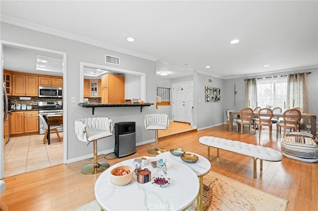 20028 Strathern St, Winnetka, CA 91306 - living area featuring light wood finished floors, crown molding, recessed lighting, and baseboards