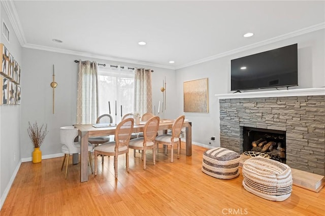 20028 Strathern St, Winnetka, CA 91306 - dining space featuring baseboards, light wood finished floors, ornamental molding, recessed lighting, and a stone fireplace