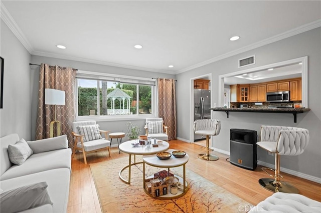 20028 Strathern St, Winnetka, CA 91306 - living area featuring light wood-type flooring, recessed lighting, crown molding, and baseboards