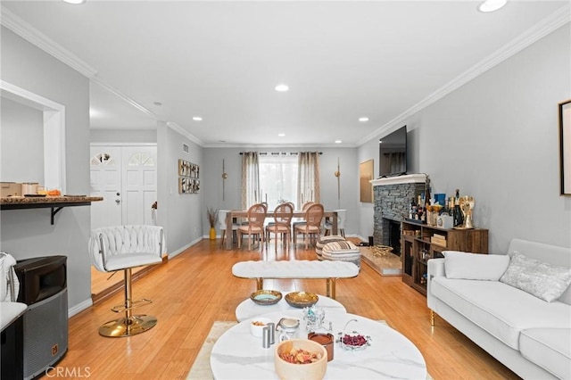 20028 Strathern St, Winnetka, CA 91306 - living area featuring light wood-type flooring, ornamental molding, recessed lighting, a fireplace, and baseboards