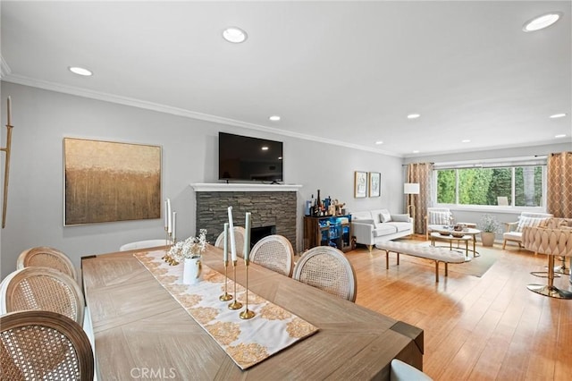 20028 Strathern St, Winnetka, CA 91306 - dining area with recessed lighting, crown molding, a fireplace, and wood finished floors