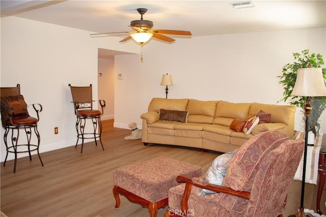 1301 Charterten Ave, Bakersfield, CA 93307 - living room featuring wood finished floors, a ceiling fan, and baseboards