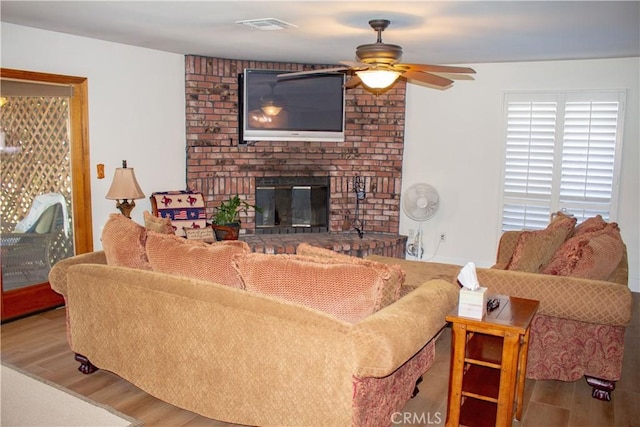 1301 Charterten Ave, Bakersfield, CA 93307 - living room with a ceiling fan, wood finished floors, and a fireplace