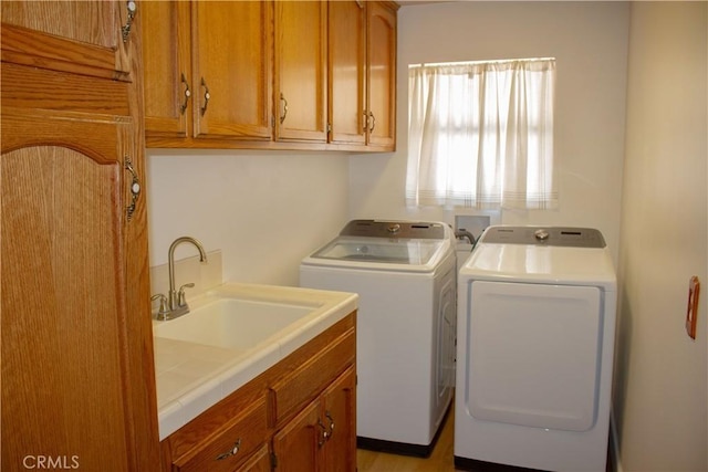 1301 Charterten Ave, Bakersfield, CA 93307 - washroom featuring washing machine and dryer and cabinet space