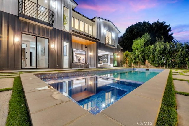 11835 Kling St, Valley Village, CA 91607 - pool at dusk featuring a patio area and a pool with connected hot tub