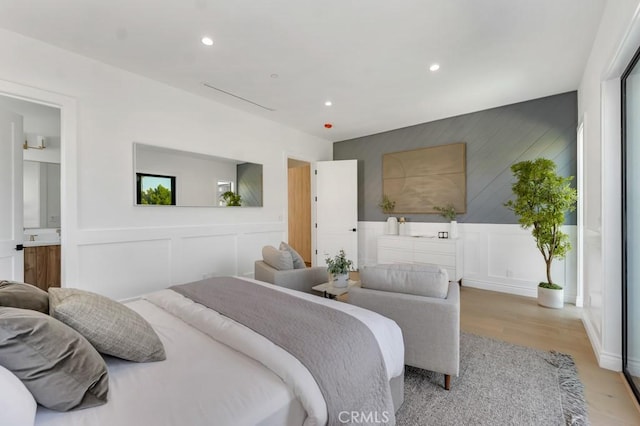 11835 Kling St, Valley Village, CA 91607 - bedroom featuring light wood-style floors, recessed lighting, and a decorative wall