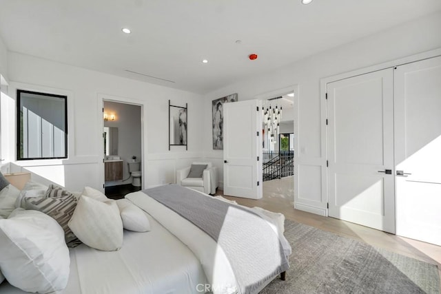 11835 Kling St, Valley Village, CA 91607 - bedroom featuring recessed lighting, light wood-type flooring, connected bathroom, and a decorative wall