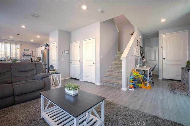 5240 Wintercress Ave, Fontana, CA 92336 - living room with wood finished floors, stairway, and recessed lighting