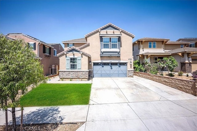 5240 Wintercress Ave, Fontana, CA 92336 - view of front of home featuring stucco siding, driveway, stone siding, a garage, and a tile roof